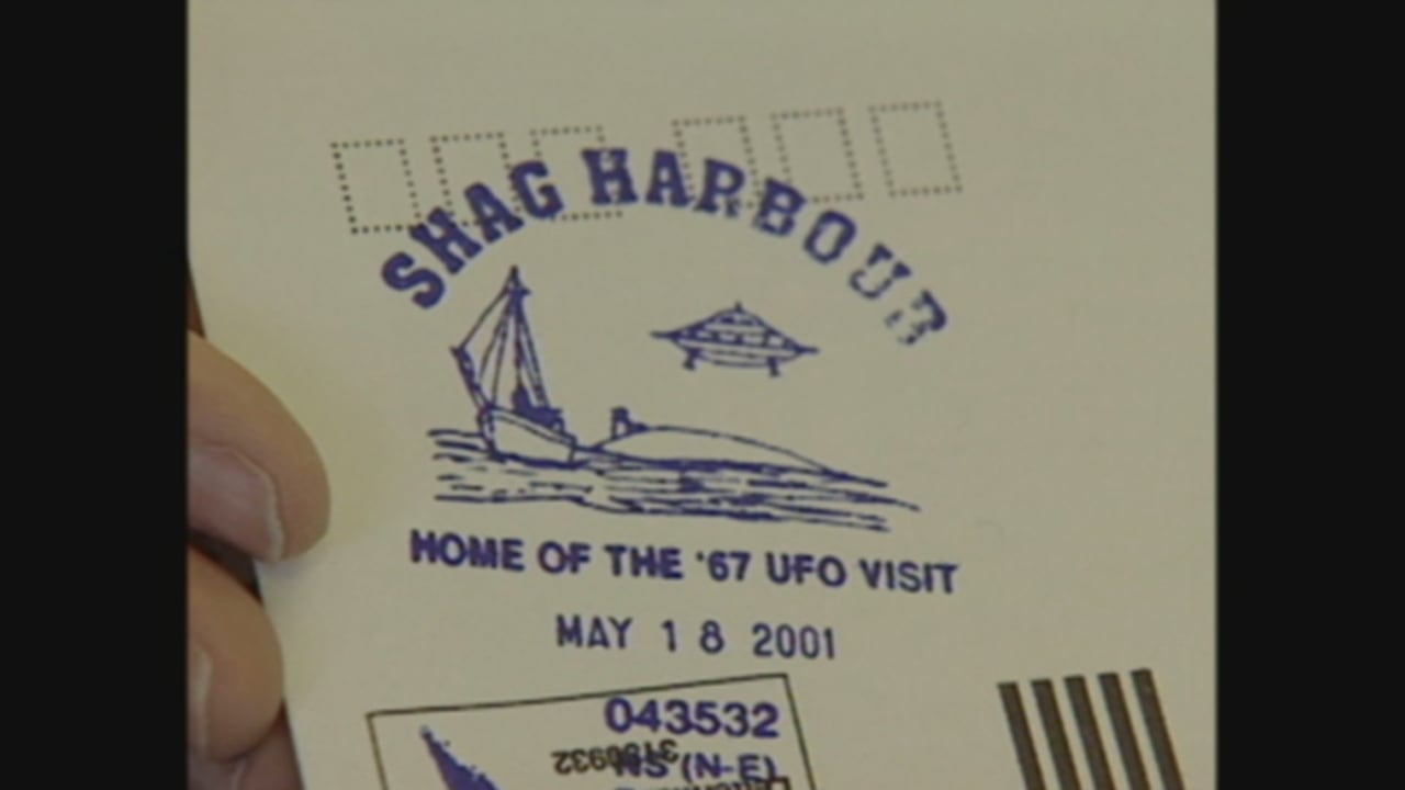 A postmark shows a UFO hovering above water.