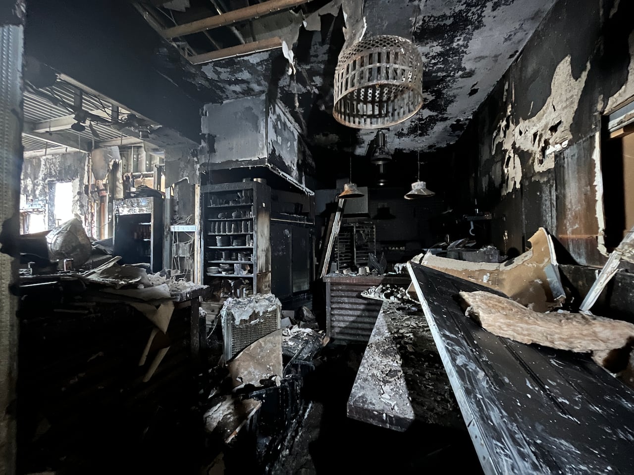 The interior of the restaurant, damaged and covered in ash from the fire.