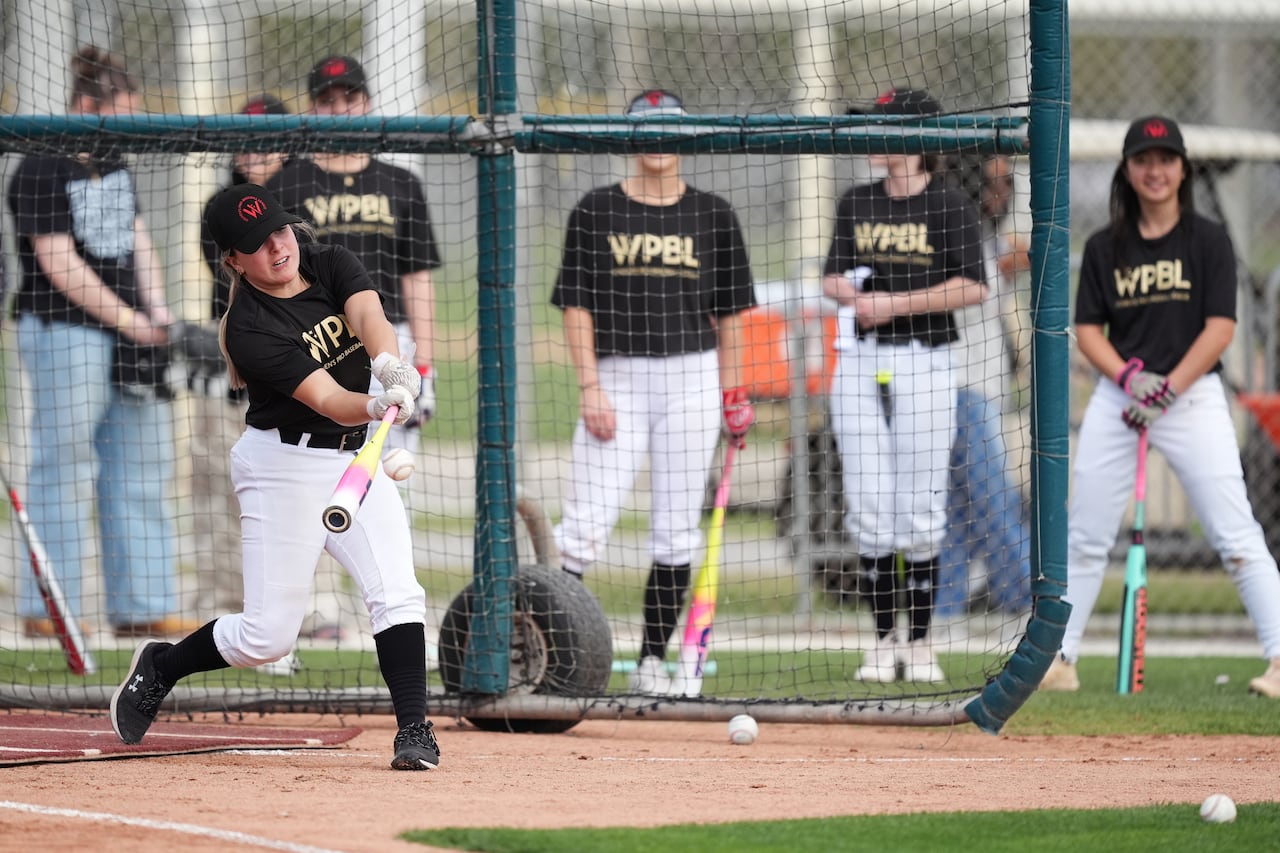 Canadian baseball player Elodie Ciamarro hits a ball during a batting practice session.