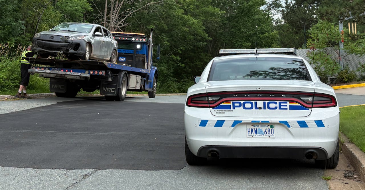 A grey Mazda that is part of a police investigation is shown being towed.