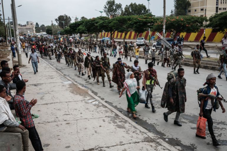 Tigrayan fighters walk in formation in Mekele, the capital of Ethiopia’s Tigray region, on June 30, 2021. [Yasuyoshi Chiba/AFP]