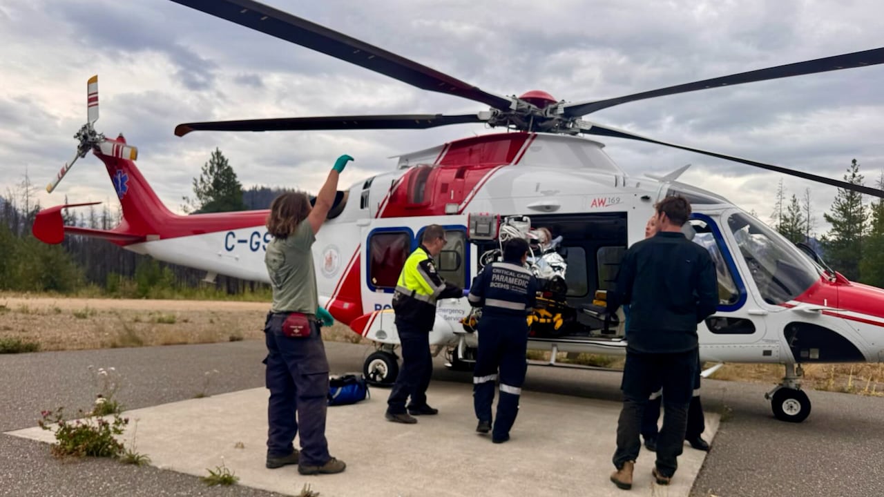 People rescuing an individual who was attacked into an airplane