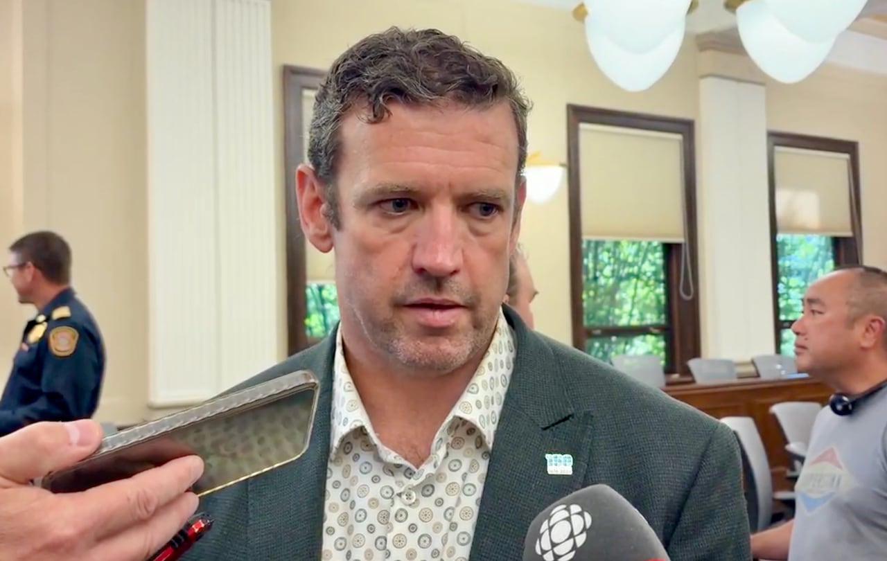 A man speaks to a reporter.