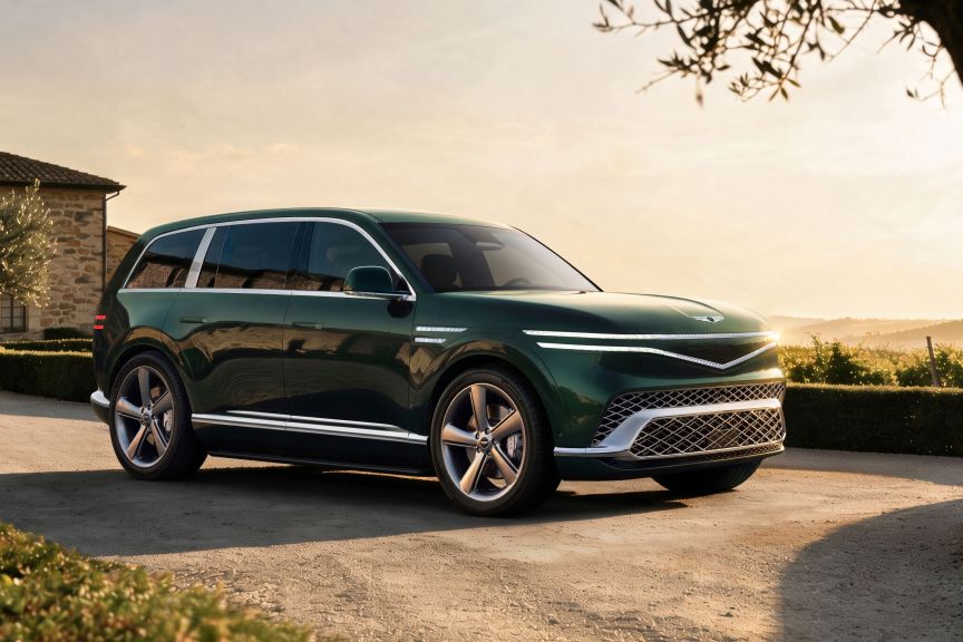 Genesis GV90 Standard, parked in a driveway at sunset with green paint