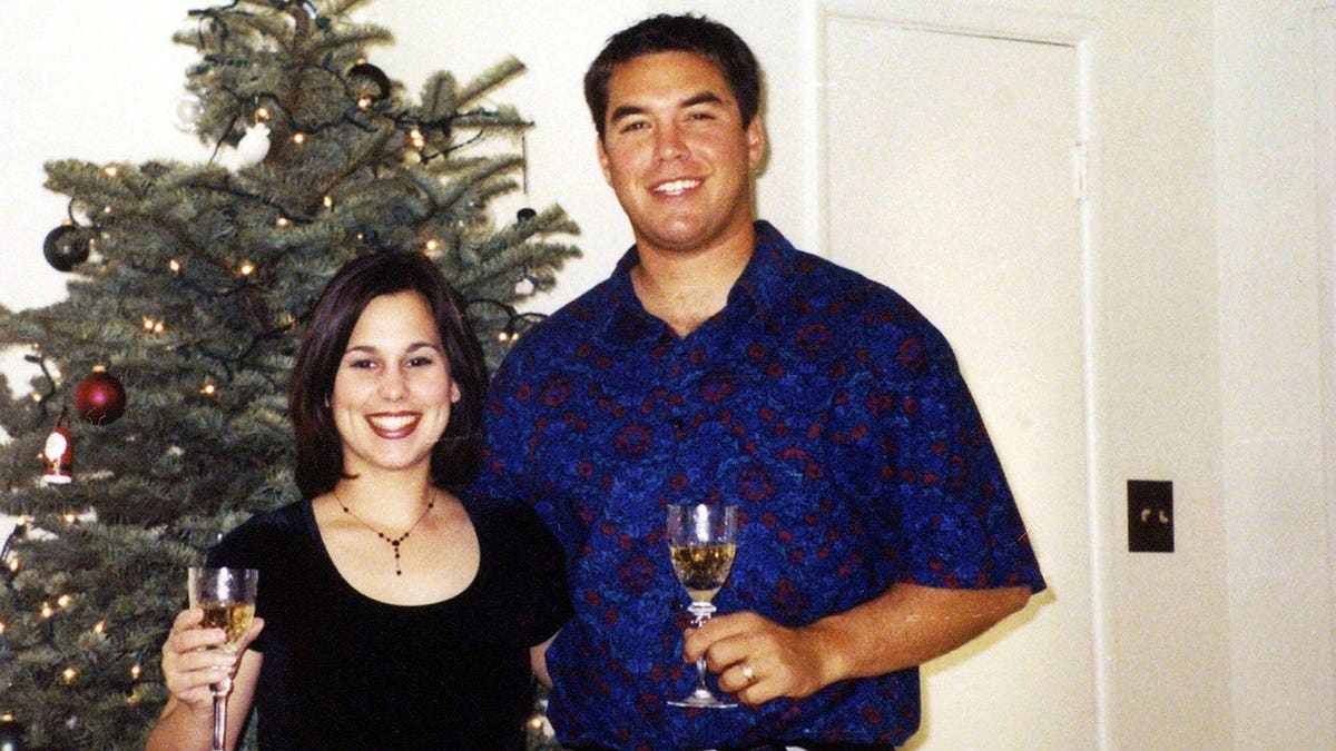 Laci Peterson and Scott Peterson stand together in a home setting.