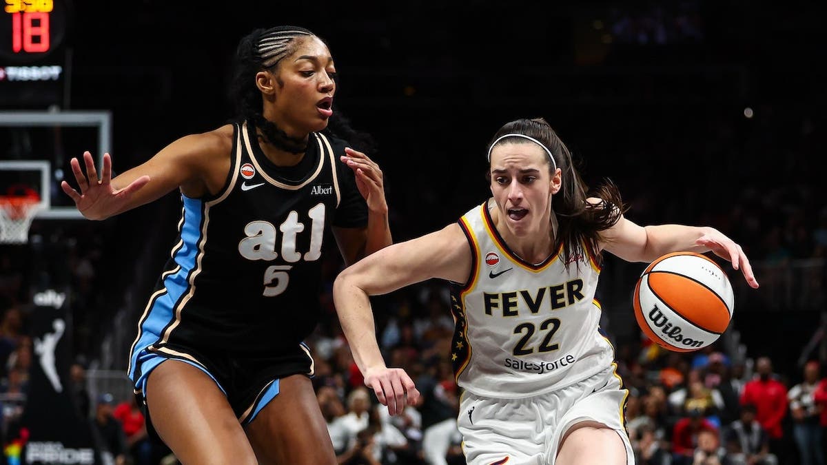 Caitlin Clark driving to the basket against Angel Reese at State Farm Arena in Atlanta