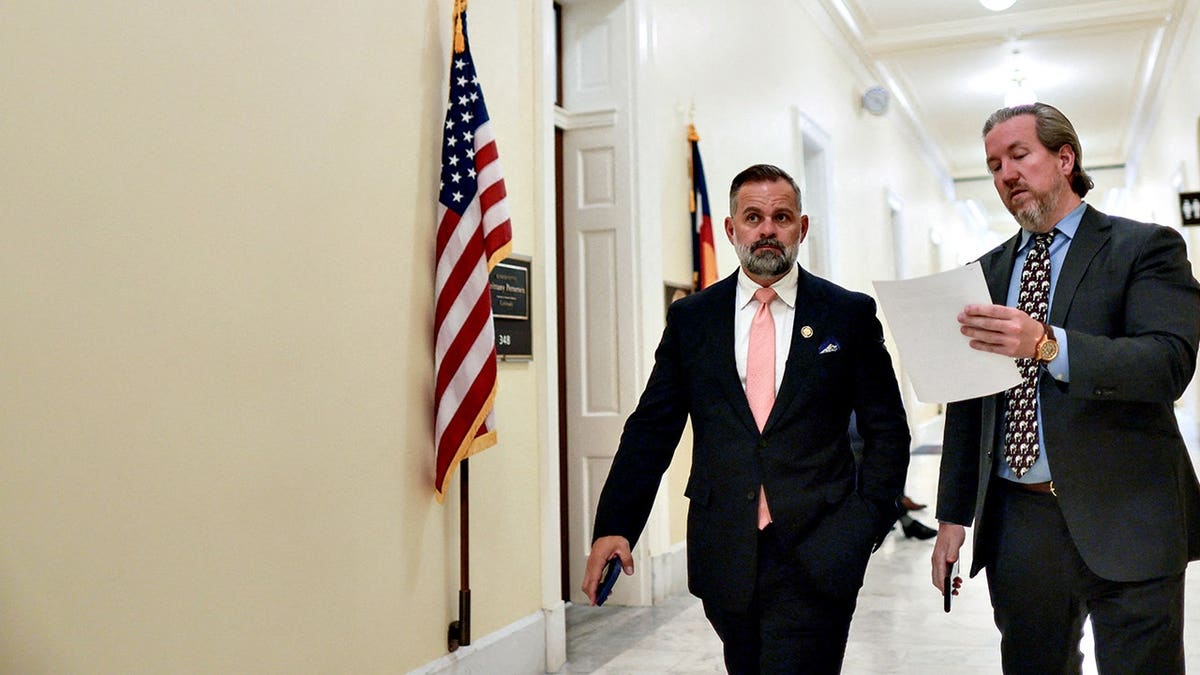 Rep. Cory Mills walks with an aide near his office on Capitol Hill.