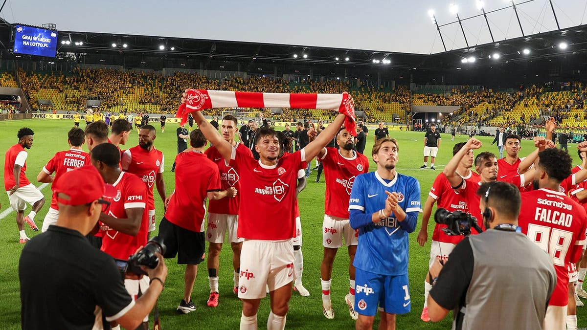 Hapoel Tel Aviv players celebrate during a UEFA Conference League match in Katowice, Poland.