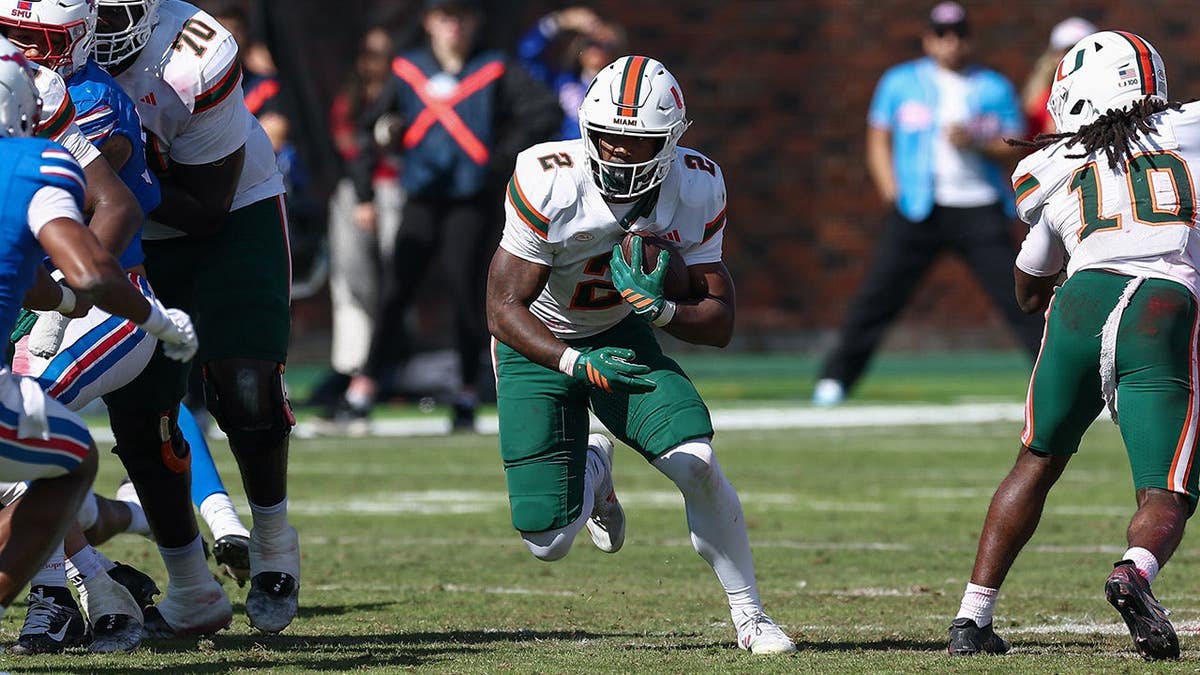 Jordan Lyle, Miami Hurricanes running back, runs up field during a college football game.