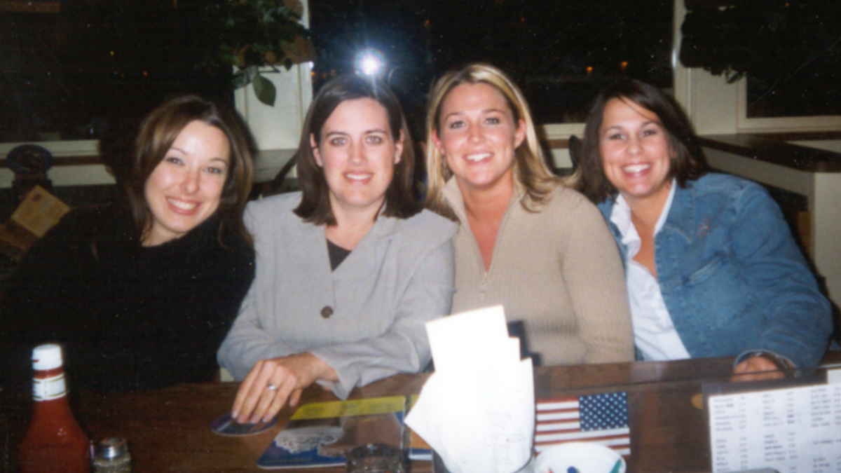 Laci Peterson and friend Kim Juarez sit with two other friends at a birthday dinner in California in 2002