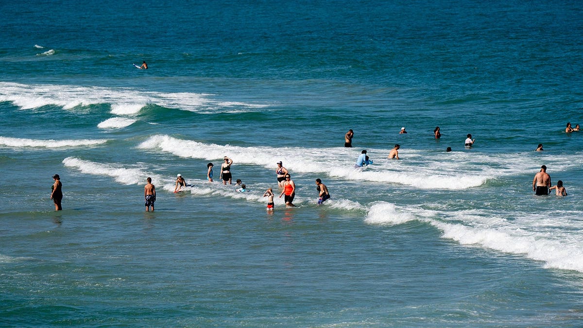 People cool off in the ocean at Kure Beach, North Carolina.