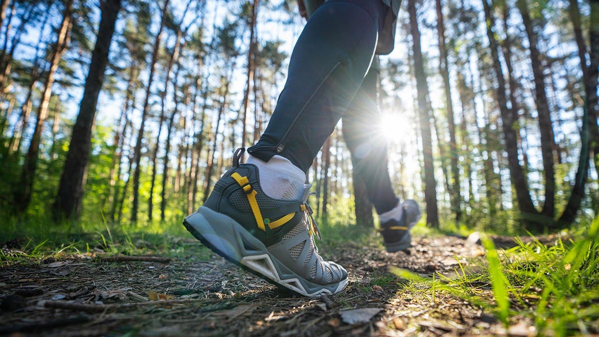 A person runs in the woods.