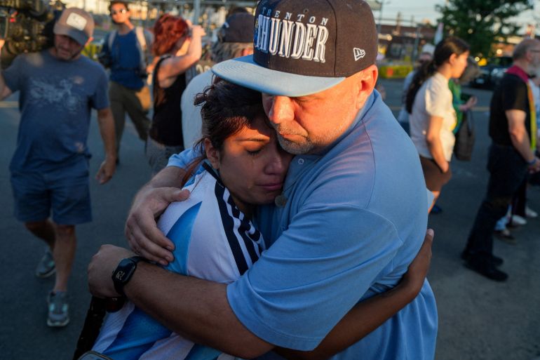 Gabriela Soto, whose husband has been in ICE detention for more than five months, cries as she hugs a protester outside of Delaney Hall detention center, after a Salvadoran immigrant, Edwin Lopez-Cornejo, who was being held inside died on Saturday, in Newark, New Jersey, U.S., August 3, 2026. REUTERS/Ryan Murphy REFILE - CORRECTING SURNAME FROM "LOPEZ-CONEJO" TO "LOPEZ-CORNEJO".