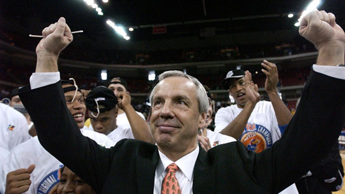 Roy Williams celebrates as Kansas players cut down the net after beating Oregon.