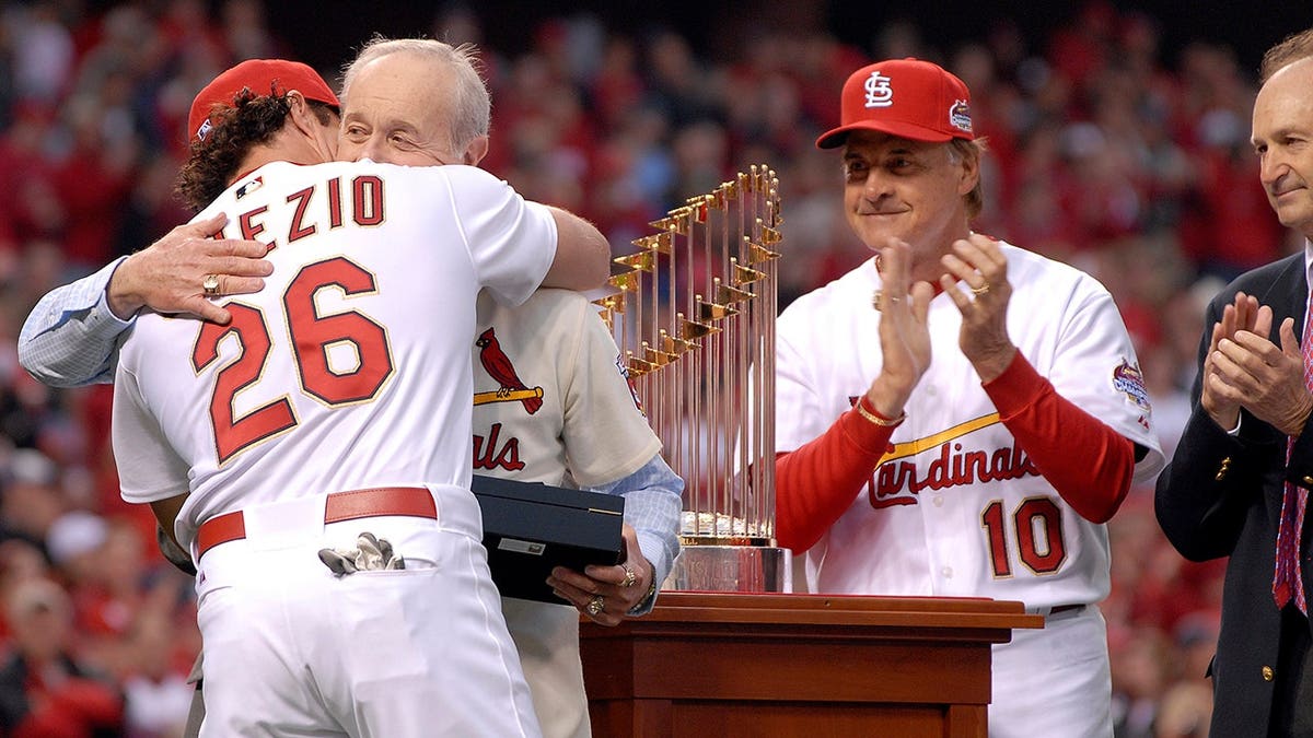 Scott Spiezio receives his World Series ring from his father Ed during a ceremony at Busch Stadium.