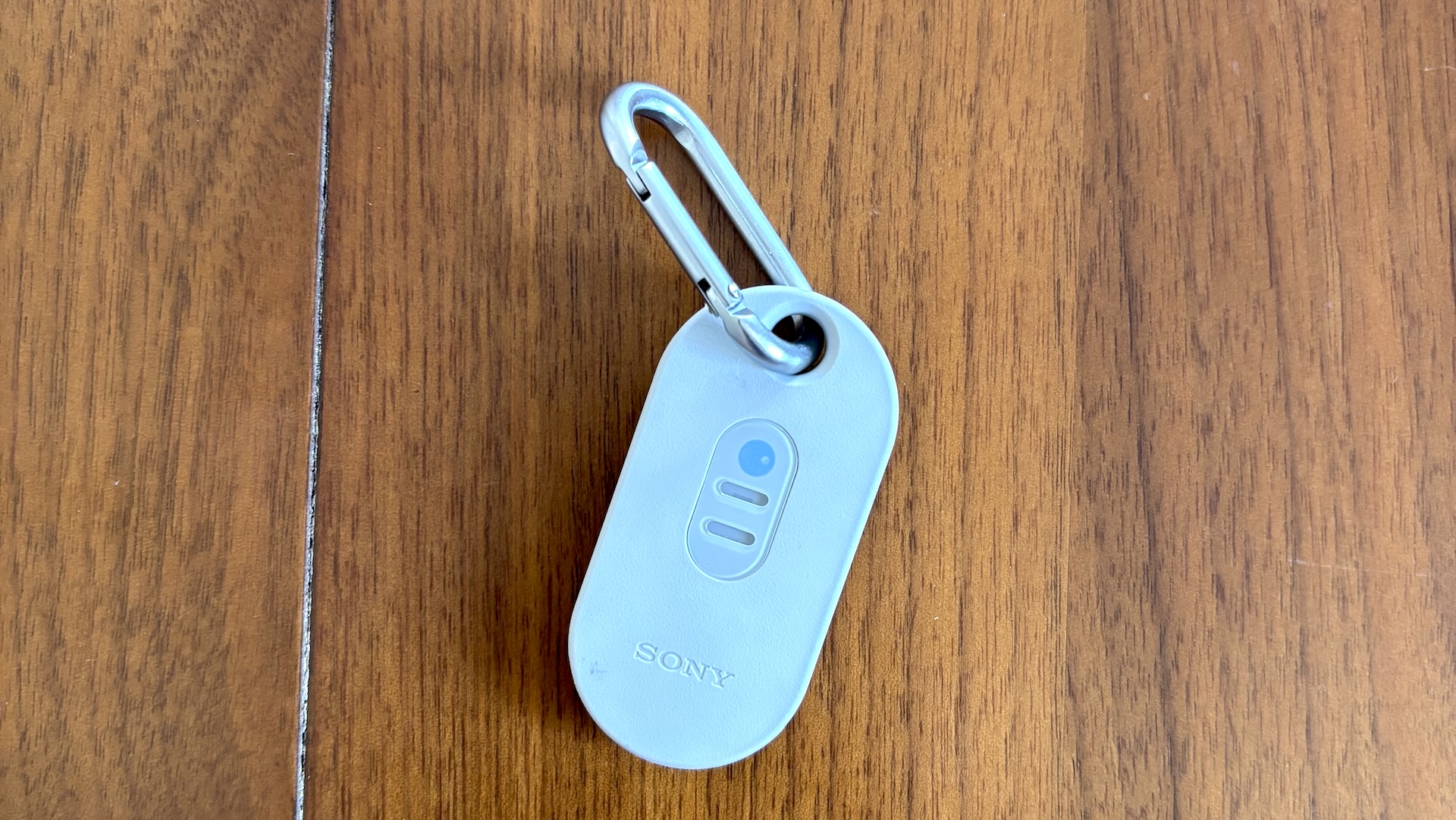 The Sony Reon Pocket Pro Plus sensor tag on a wood table.