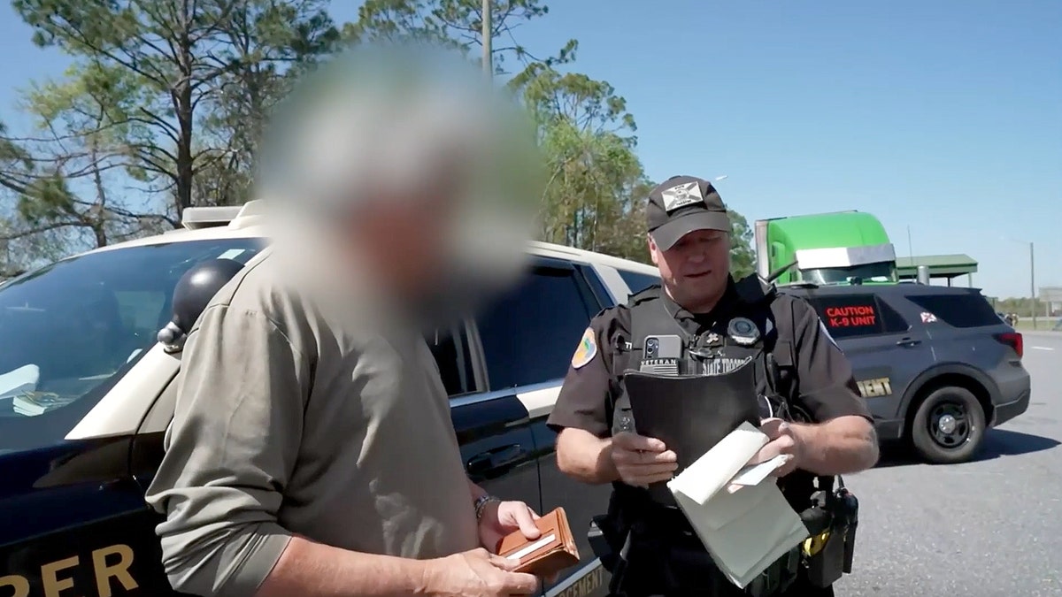 State trooper talking with a truck driver