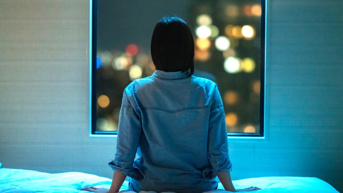 Woman at window can't sleep