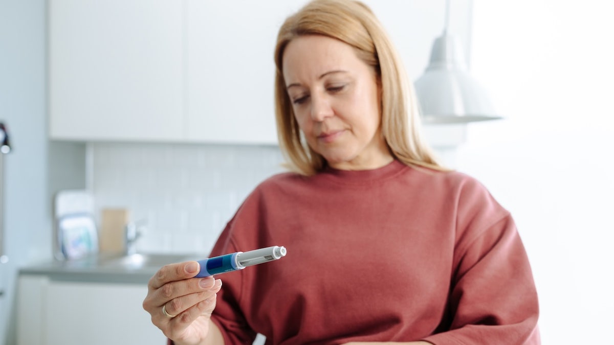 Woman looking at weight-loss injection