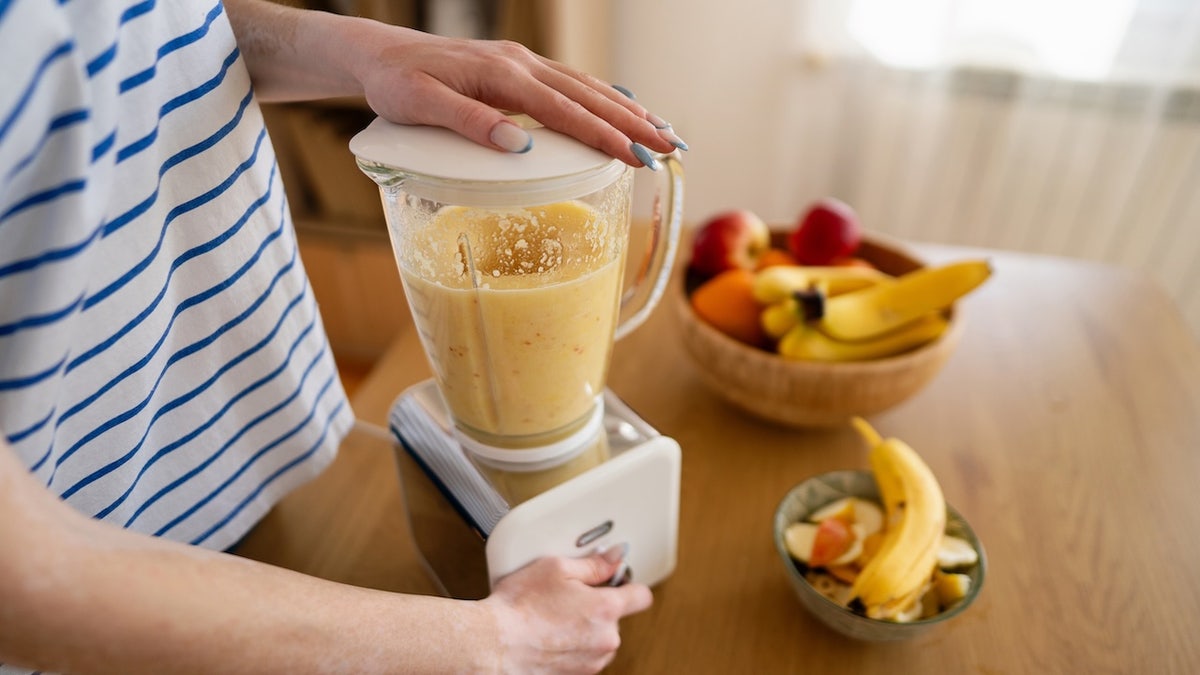 Woman making banana smoothie