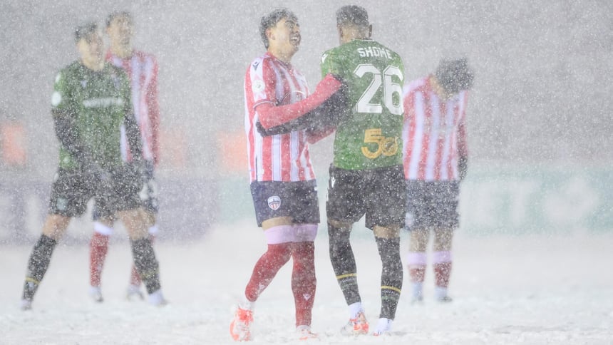 Soccer players in the snow.