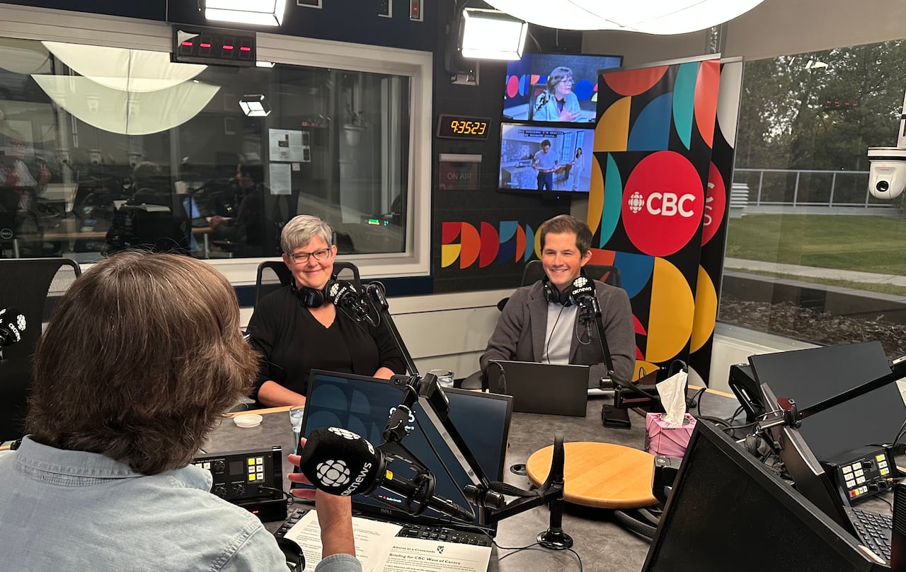 radio studio with young man and older woman smiling
