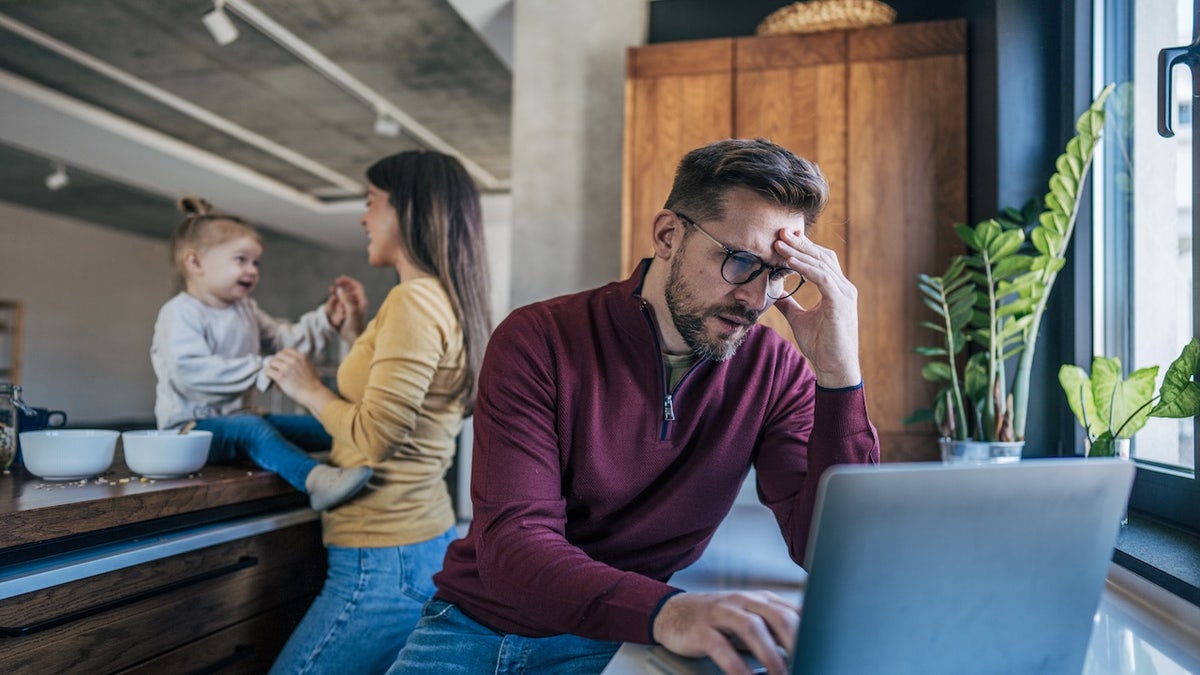 Workaholic man with wife and child