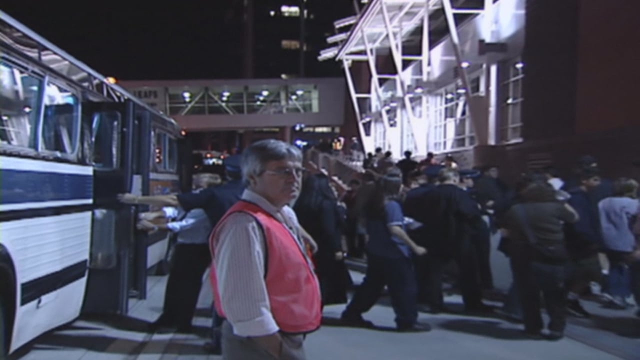 Group of people getting off bus.