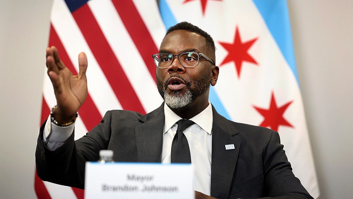 Brandon Johnson speaking at a press conference.