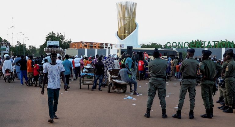 People gather at the Place de la Concertation as security personnel stand guard following a mutineers' attack on the airport and the presidency in Niamey, Niger, August 29, 2026. REUTERS/Stringer